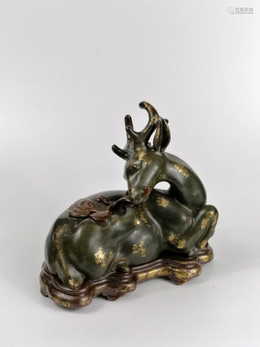 Fine teadust-glazed deer holding a Lingzhi