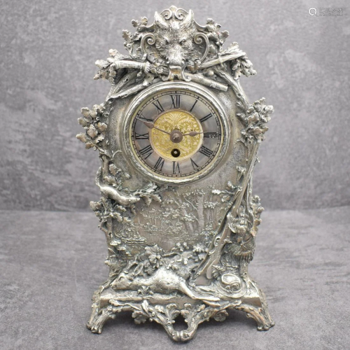 Unusual table clock with lavish hunting motive