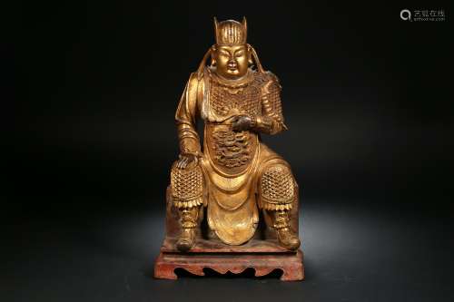 A gilt bronze statue of the god of wealth in the Qing Dynast...