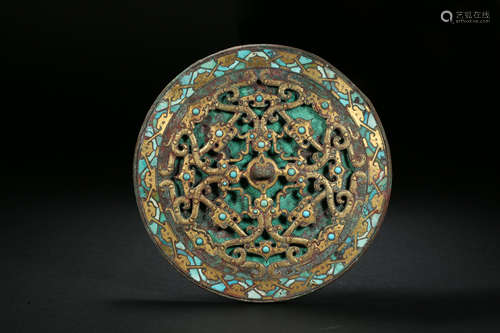 A bronze mirror with gold and silver inlaid with turquoise a...