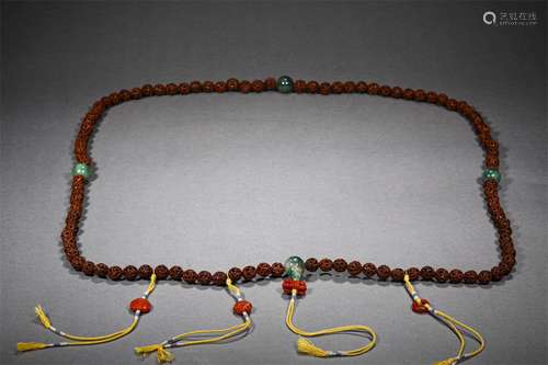 A QING DYNASTY PEACH-STONE CARVING HAND STRINGS