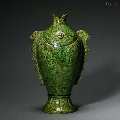 TANG DYNASTY, CHINESE GREEN-GLAZED TWISTED FISH SHAPED BOTTL...