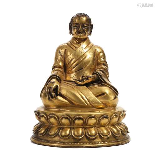 A GILT-BRONZE FIGURE OF A SEATED LAMA