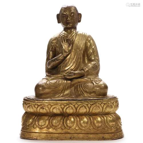 A GILT-BRONZE FIGURE OF A LAMA