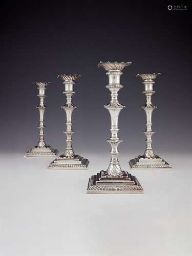 A set of four early George III cast silver square candlestic...