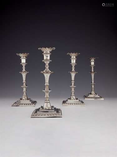 A set of four early George III cast silver square candlestic...