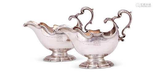 A pair of George II silver oval pedestal sauce boats by Geor...