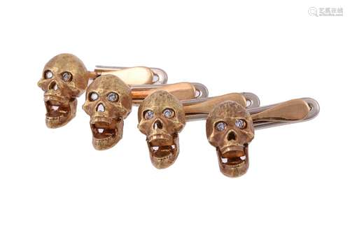 A set of four diamond set skull dress studs by William & Son