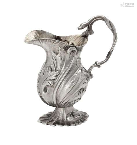 A late George II cast silver baluster cream jug by Peter Wer...