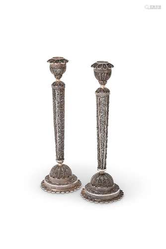 A pair of silver filigree circular candlesticks