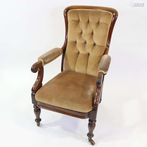 A Victorian mahogany framed open arm fireside chair