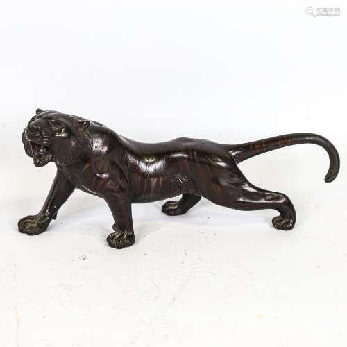 A Japanese patinated bronze striped tiger, seal mark under b...