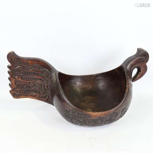 A large Russian carved and stained wood bowl, in the style o...