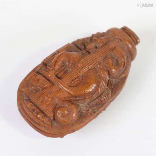 An 18th century coquilla nut snuff bottle, relief carved all...