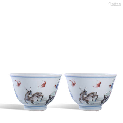 A pair of small cups with story lines of pastel figures in Q...