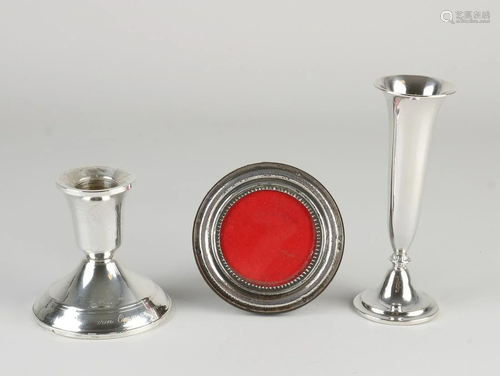 Three parts of silver, including a round photo frame