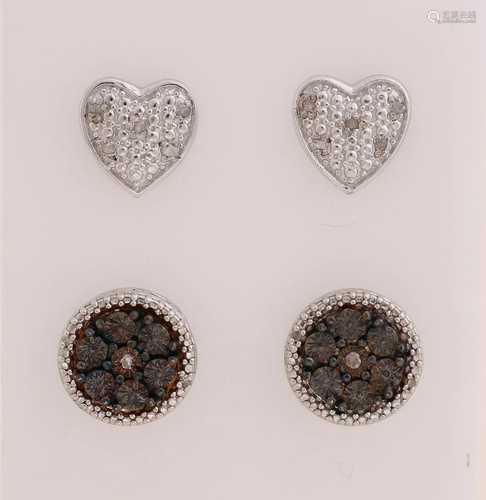 Two pairs of silver ear studs, 925/000, with diamond. A