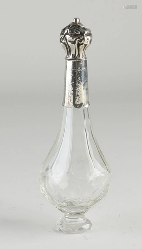 Crystal odor bottle on a round foot with grinding work.