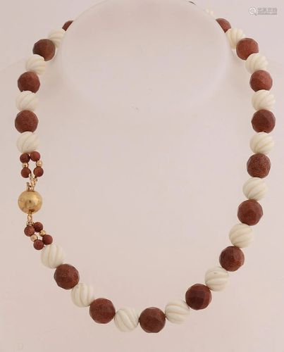 Necklace of goldstone beads and carved bone beads,