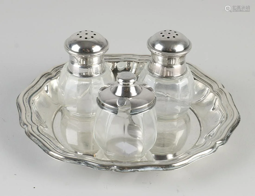 Spice set with silver. A round contoured silver tray,