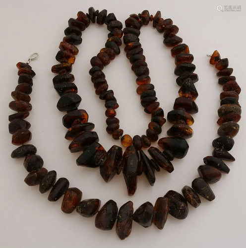 Two necklaces of dark amber, one long necklace with