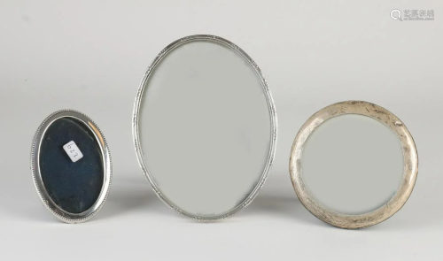 Three silver photo frames, a frame with a round smooth