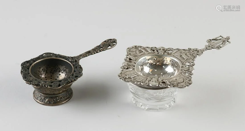 Two silver tea strainers, 833/000, one square openwork