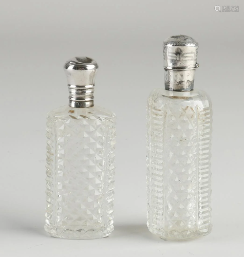 Two cut crystal odor flasks with silver collar and cap,