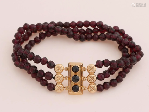 Bracelet with faceted garnet beads attached to a yellow