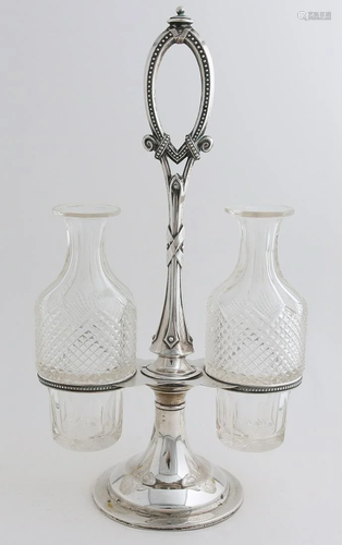 Crystal oil and vinegar set in a silver holder,