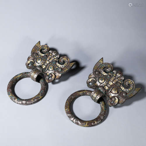 A pair of beast face patterned bronze rings