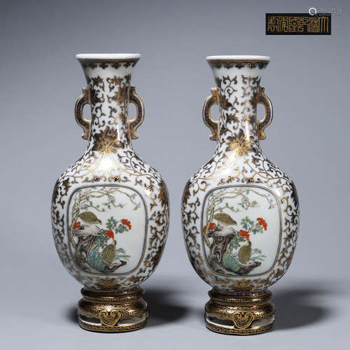 A pair of ink colored gilt bird and flower porcelain vases