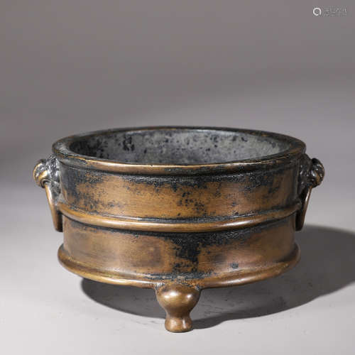 A copper censer with lion head shaped ears