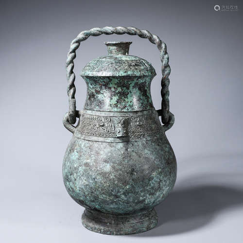 A taotie patterned loop-handled bronze pot