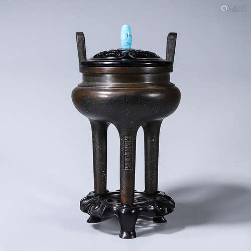 A double-eared three-legged copper censer