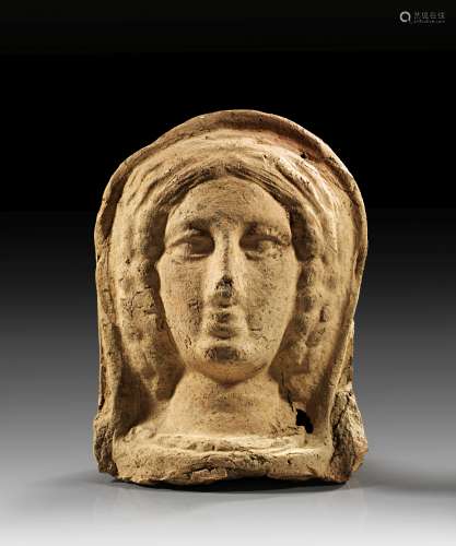 Etruscan votive head of a young lady.