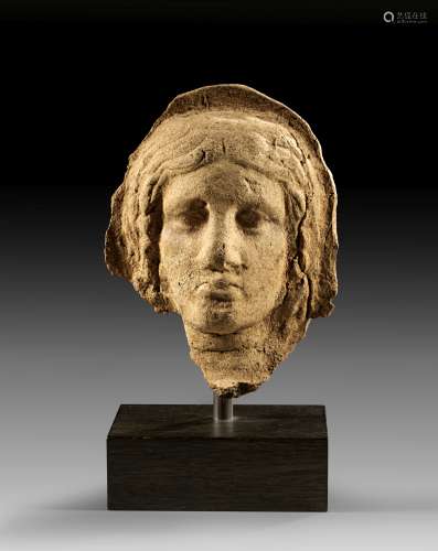 Terracotta votive head of a veiled woman.