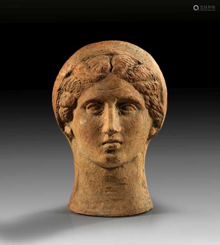 Terracotta votive head of a veiled woman.