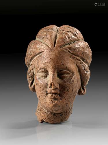 Terracotta head of a girl with melone hairstyle.