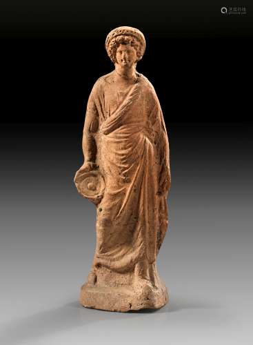 Terracotta of a draped youth with wreath and phiale.