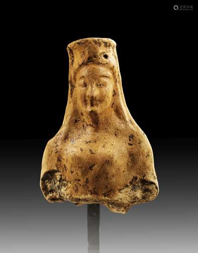 Upper part of a terracotta statuette of a young veiled woman...