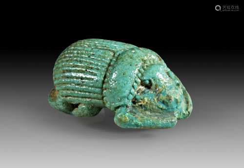 Naturalistically shaped faience scarab amulet.