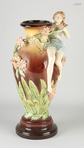 Old majolica vase with floral/half-naked woman decor.