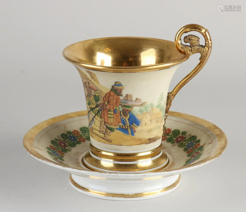 French gilded porcelain Empire cup and saucer with text