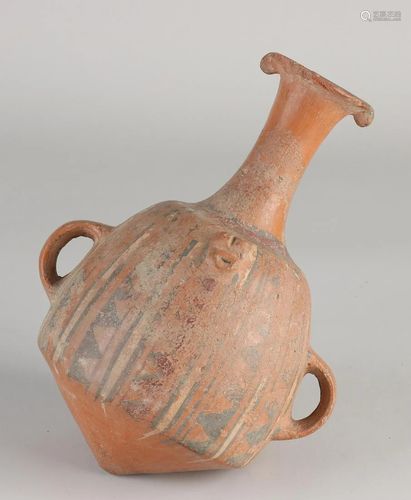 Antique terracotta amphora jug with ears and residual