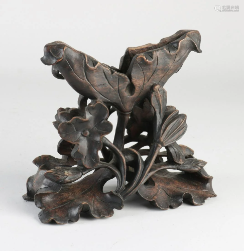 Antique Chinese wood-carved stand with floral decor.