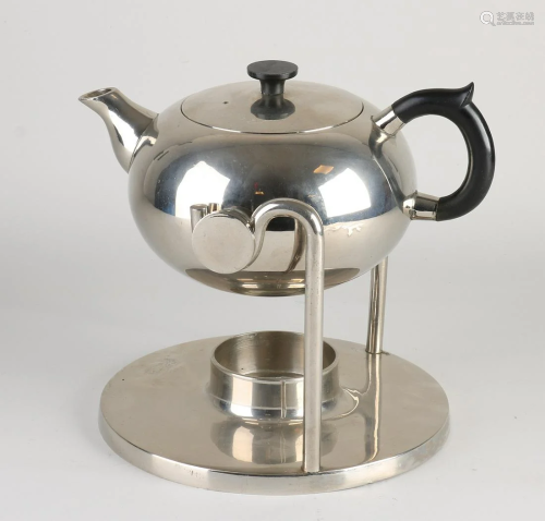 Bauhaus style chromed brass tumbler kettle on stove.