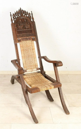 Antique hardwood carved Indonesian chair with rattan