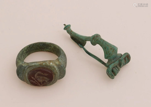 Roman ring and fibula, archaeological find. Heavy ring