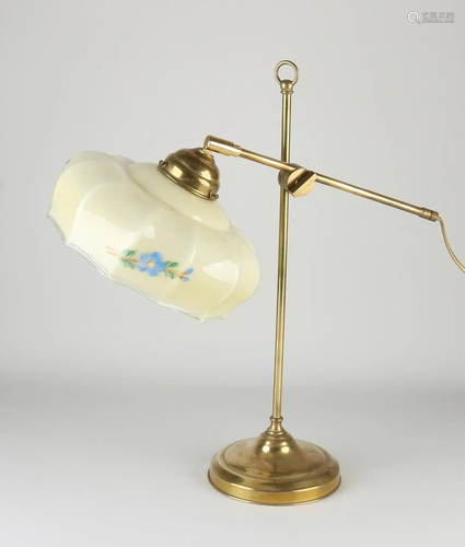 Old brass table lamp with antique flowered glass shade.